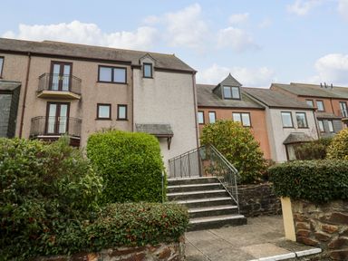 Exterior view of a residential building with balconies stairs and hedges at Fal View in Falmouth