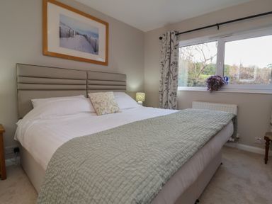 A bedroom with a bed and a window at Little Willesleigh in Goodleigh near Barnstaple