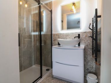 A bathroom with a shower and sink at Little Willesleigh Goodleigh near Barnstaple