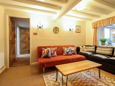 A living room with a sofa and coffee table at Bryn Y Garreg - The Wireless Free Farm (No Tech!) Y Trallwng