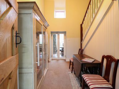 A hallway with a door and a cabinet at Bryn Y Garreg - The Wireless Free Farm (No Tech!) Y Trallwng