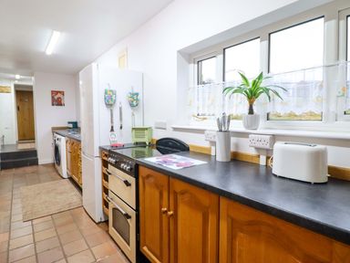 A kitchen with a refrigerator, oven, and countertop at Bryn Y Garreg - The Wireless Free Farm (No Tech!) in Y Trallwng