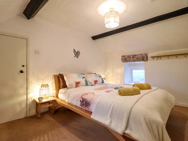 A bedroom with a bed and towels at Bryn Y Garreg - The Wireless Free Farm (No Tech!) Y Trallwng