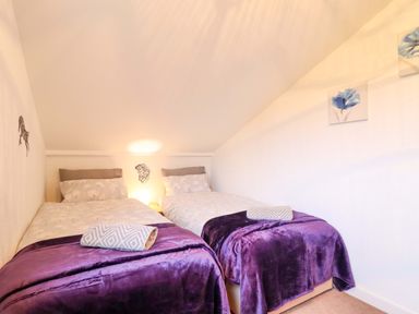 A bedroom with two beds and wall art at Bryn Y Garreg - The Wireless Free Farm (No Tech!) in Y Trallwng