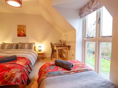 A bedroom with two beds and a desk at Bryn Y Garreg - The Wireless Free Farm (No Tech!) in Y Trallwng