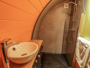 A bathroom with a round sink faucet and a walk-in shower with a towel hanging at Hobhole in Keal Cotes near East Kirkby