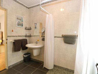 A bathroom with a shower and sink at Rainbow's End in Swanton Morley