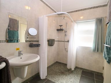 A bathroom with a shower and sink at Rainbow's End in Swanton Morley