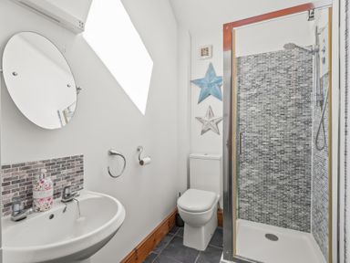 A bathroom with a sink mirror toilet and a shower at The Stables in St Neot