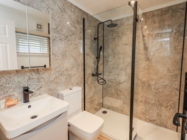 A bathroom with a shower, toilet and sink at Lakeside Lodge Bowland Lakes Leisure Village near Garstang