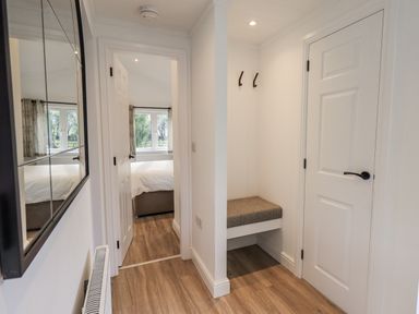 A hallway with a mirror and bench at Lakeside Lodge Bowland Lakes Leisure Village near Garstang