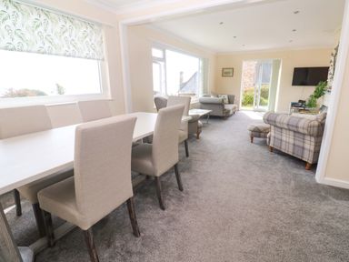 A dining room with a table and chairs at Karenza in Penzance