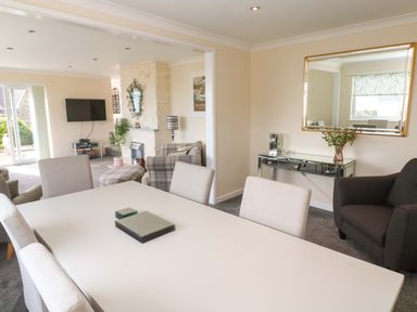 A dining room with a table and chairs at Karenza in Penzance