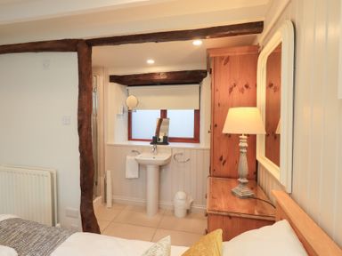A bedroom with a sink and lamp at Jasmine Cottage Thornthwaite