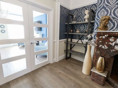 An entryway with a door, shelf, and vase at Apartment 1 in Weymouth