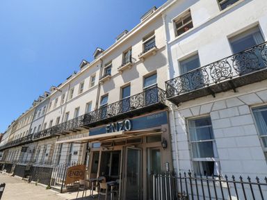 An exterior view of the ENZO restaurant with balconies in Weymouth