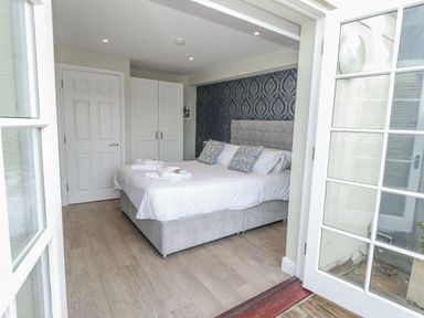 A bedroom with a bed and wardrobe at Vista Mare 1 Weymouth