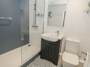 A bathroom with a shower, sink, and toilet at Vista Mare 1 Weymouth