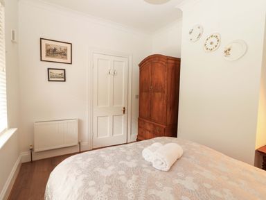 A bedroom with a bed and wardrobe at Rosemont in Adare