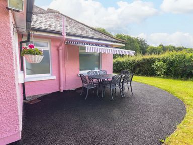 An outdoor seating area with a table and chairs at Rosemont in Adare