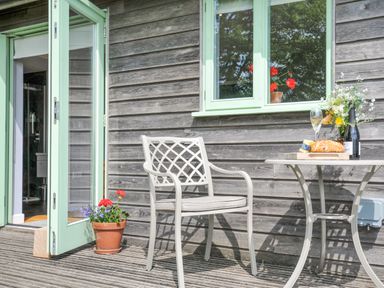 An outdoor patio with a table and chair at Smugglers Bodmin Moor, St Breward near St Tudy