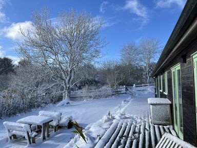 An outdoor area with a table and chairs in snow at Smugglers Bodmin Moor, St Breward near St Tudy