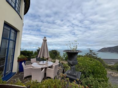 An outdoor dining area with a table and chairs at Bayview Tower in Lynton