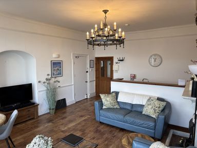 A living room with a sofa and television at Bayview Tower in Lynton