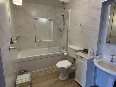 A bathroom with a bathtub, toilet and sink at Bayview Tower in Lynton