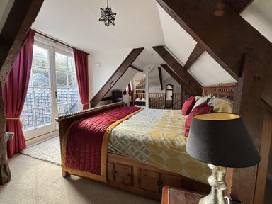 A bedroom with a bed and window at Bayview Tower in Lynton