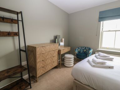 A bedroom with a bed and shelving at Weyside in Weymouth