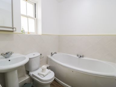 A bathroom with a bathtub, sink, and toilet at Weyside in Weymouth