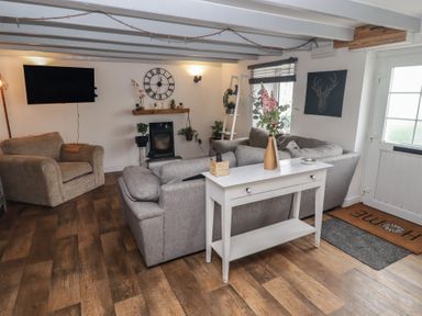 A living room with a sofa and armchair at 41 St. James Street Narberth