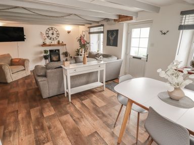 A living room with a sofa and dining table at 41 St. James Street Narberth
