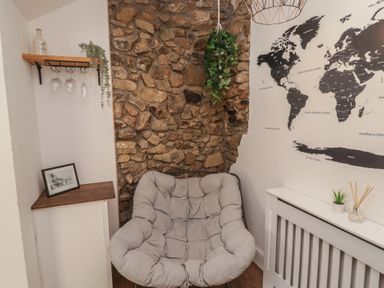 A sitting area with a chair and decorative items at 41 St. James Street Narberth