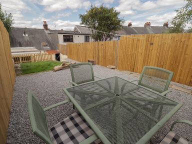 A garden with a table and chairs at 41 St. James Street in Narberth
