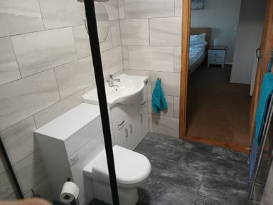A bathroom with a toilet and sink at The Dairy Barn in Camelford