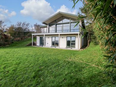 A house with balcony and large windows at Green Shutters Freshwater East near Lamphey