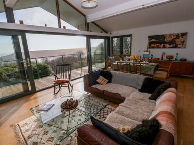 A living room with a sofa and a coffee table at Green Shutters in Freshwater East near Lamphey