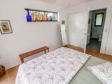 A bedroom with a bed and window at Green Shutters in Freshwater East near Lamphey