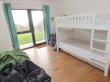 A bedroom with a bunk bed and bean bags at Green Shutters Freshwater East near Lamphey