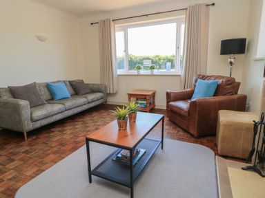 A living room with a coffee table and seating at Bayview Cottage in Southbourne