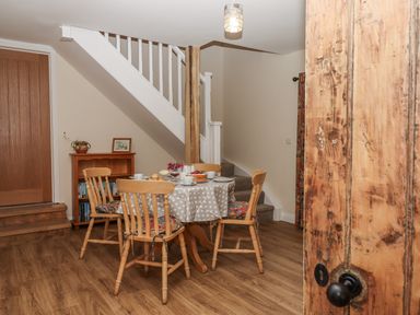 A dining room with a table and chairs at Aunty Junes Cottage Okehampton