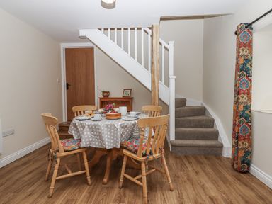 A dining area with a table and chairs at Aunty Junes Cottage Okehampton