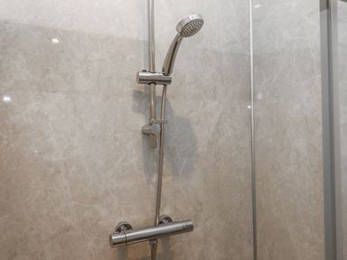 A shower system with a handheld showerhead and valve at Aunty Junes Cottage Okehampton