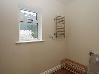 A utility room with a window and towel rail at Aunty Junes Cottage in Okehampton