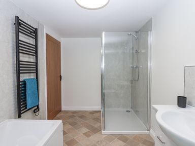 A bathroom with a shower and a bath tub at Aunty Junes Cottage in Okehampton