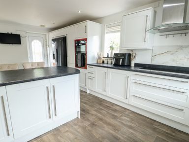 A kitchen with cabinets and appliances at 9 Beckett Close Colwyn Bay