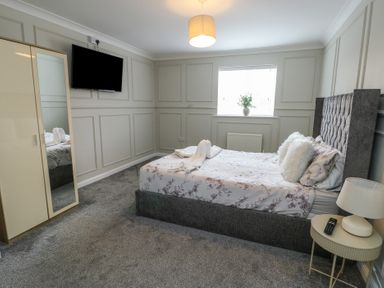 A bedroom with a bed and TV at 9 Beckett Close in Colwyn Bay