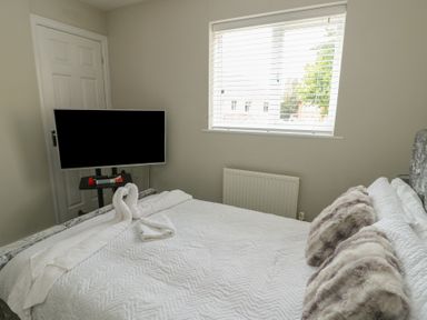 A bedroom with a bed and television at 9 Beckett Close Colwyn Bay